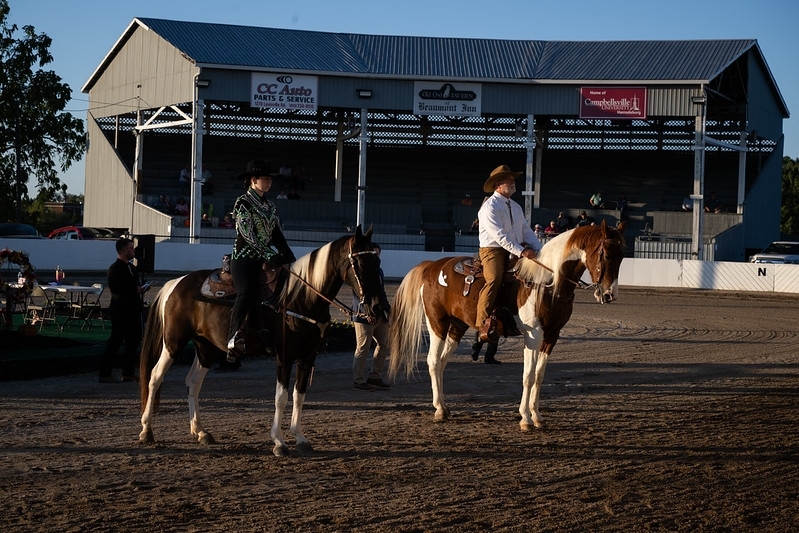 Two riders on horseback at a horse show