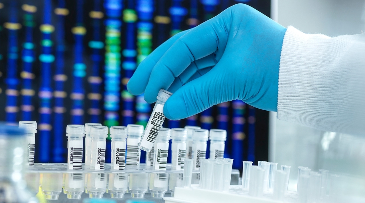 test-tubes-genetic-sequencing-adobe-450842152.jpeg a gloved hand with test tubes in a lab setting