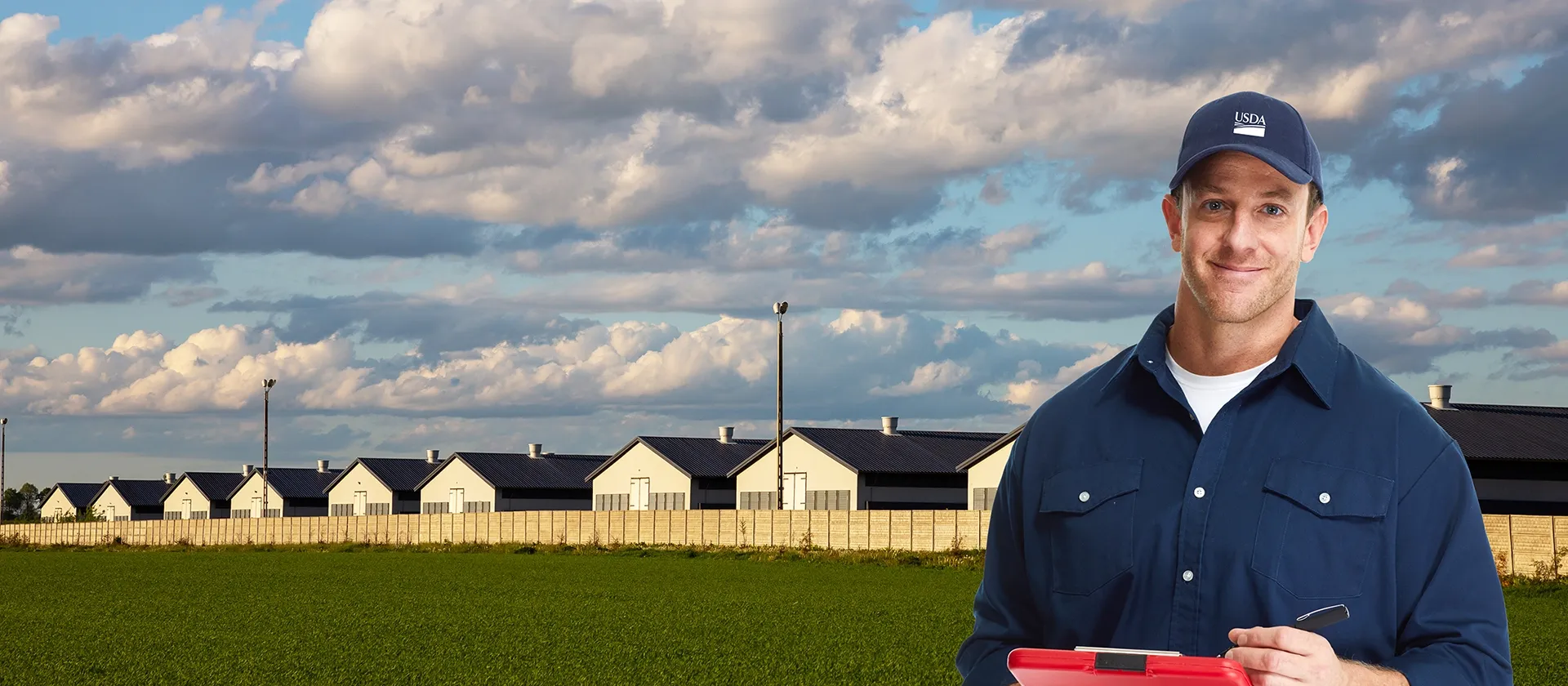 USDA employee standing outside poultry houses